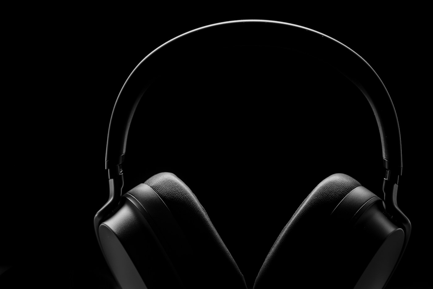 Black over-ear headphones against a dark background